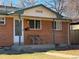 Brick ranch house with covered entryway and two chairs at 7505 Clay St, Westminster, CO 80030