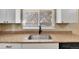 Kitchen features granite countertops, stainless steel sink, and white cabinets at 7505 Clay St, Westminster, CO 80030