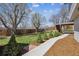 A serene backyard featuring mature trees, a lush lawn, and manicured landscaping at 1479 S Jasper St, Aurora, CO 80017