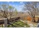 View of a well-maintained backyard featuring grass, mature trees, and a wooden fence at 1479 S Jasper St, Aurora, CO 80017