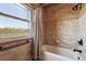 Beautiful bathroom with tiled shower, tub combo, and a window providing natural light at 1479 S Jasper St, Aurora, CO 80017