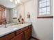 Well-lit bathroom featuring a white vanity, decorative faucet, and ample counter space at 1479 S Jasper St, Aurora, CO 80017