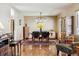 An inviting dining room features hardwood floors, a modern light fixture, and rustic wooden furniture at 1479 S Jasper St, Aurora, CO 80017