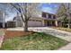 Charming two-story home features a well-manicured lawn, garage, and inviting front porch at 1479 S Jasper St, Aurora, CO 80017