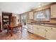 Bright kitchen featuring white cabinetry, tile floors, and a cozy breakfast nook with backyard access at 1479 S Jasper St, Aurora, CO 80017