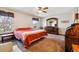 Cozy main bedroom with a ceiling fan, large window, and ample space for furniture at 1479 S Jasper St, Aurora, CO 80017