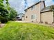 Expansive backyard with lush green grass, mature trees, and a patio for outdoor enjoyment at 6188 Viewpoint Ave, Firestone, CO 80504