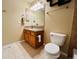 Standard bathroom featuring a single vanity, mirror, and toilet with tiled flooring at 6188 Viewpoint Ave, Firestone, CO 80504