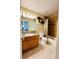 Bathroom with linoleum floors, oak vanity, and shower/tub combo at 6188 Viewpoint Ave, Firestone, CO 80504