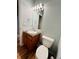 Bathroom with oak cabinets, white sink, and toilet at 6188 Viewpoint Ave, Firestone, CO 80504