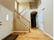 Welcoming foyer with gleaming hardwood floors, a striking staircase and neutral decor at 6188 Viewpoint Ave, Firestone, CO 80504