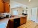 Bright kitchen featuring wood cabinets and open access to living room area at 6188 Viewpoint Ave, Firestone, CO 80504
