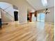 Open-concept living area with hardwood floors, a staircase, and seamless connection to the kitchen at 6188 Viewpoint Ave, Firestone, CO 80504