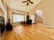 Bright living room featuring hardwood floors, fireplace, and vaulted ceilings with lots of natural light at 6188 Viewpoint Ave, Firestone, CO 80504