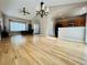 Open concept living room and kitchen with hardwood floors and large windows at 6188 Viewpoint Ave, Firestone, CO 80504