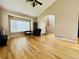 Large living room with hardwood floors, high ceilings, a fireplace, and a bay window at 6188 Viewpoint Ave, Firestone, CO 80504
