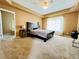 Spacious main bedroom with tray ceiling, large window, and ensuite bathroom at 6188 Viewpoint Ave, Firestone, CO 80504