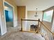 Well-lit upstairs hallway with plush carpeting, providing access to the bedrooms at 6188 Viewpoint Ave, Firestone, CO 80504