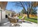 Inviting backyard with patio seating area, mature tree, and well-maintained lawn at 10601 W 78Th Ave, Arvada, CO 80005