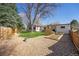 Spacious backyard featuring a patio area, lush green lawn, and rock landscaping at 10601 W 78Th Ave, Arvada, CO 80005
