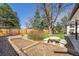 Landscaped backyard featuring a concrete table with bench seating and garden beds at 10601 W 78Th Ave, Arvada, CO 80005