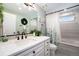 Bright bathroom featuring modern decor, ample counter space and a shower-tub combo at 10601 W 78Th Ave, Arvada, CO 80005