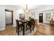 Dining room with farmhouse decor, wooden table, and sliding barn door at 10601 W 78Th Ave, Arvada, CO 80005