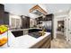 Stylish kitchen featuring dark cabinetry, stainless steel appliances, and white countertops at 10601 W 78Th Ave, Arvada, CO 80005