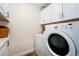 Functional laundry room with white cabinets, washer, and dryer at 10601 W 78Th Ave, Arvada, CO 80005