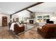 Spacious living room with hardwood floors, stone fireplace, and comfortable seating at 10601 W 78Th Ave, Arvada, CO 80005