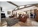 Open-concept living room featuring exposed beams and wood floors at 10601 W 78Th Ave, Arvada, CO 80005