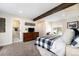 Bright main bedroom with natural light, a large bed, and an ensuite bathroom entrance at 10601 W 78Th Ave, Arvada, CO 80005