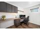 Functional home office with built-in desk, overhead cabinets, and wood-look flooring at 10601 W 78Th Ave, Arvada, CO 80005