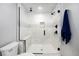 Modern shower with glass door and marble tile at 10601 W 78Th Ave, Arvada, CO 80005