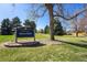 Entrance sign to Sierra Park in a green space with mature trees at 10601 W 78Th Ave, Arvada, CO 80005