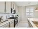 Modern kitchen with stainless steel appliances and white hexagonal backsplash at 1805 Papuan Ct, Brighton, CO 80601