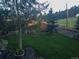 Lush backyard with a healthy lawn, beautiful landscaping, and a privacy fence at 28665 Tepees Way, Evergreen, CO 80439