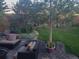 Serene backyard featuring outdoor seating area, beautiful landscaping and lush green lawn at 28665 Tepees Way, Evergreen, CO 80439