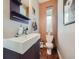 Stylish powder room with a floating vanity, modern faucet, and a vertically oriented window at 28665 Tepees Way, Evergreen, CO 80439