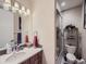 Well-lit bathroom featuring a modern vanity, sleek mirror, and a glass-enclosed shower for a clean aesthetic at 28665 Tepees Way, Evergreen, CO 80439