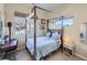 Bright bedroom featuring a unique bed frame, carpet floors and a work desk at 28665 Tepees Way, Evergreen, CO 80439
