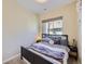 Cozy bedroom featuring a dark wood bed frame, plush bedding, and a window providing natural light at 28665 Tepees Way, Evergreen, CO 80439