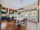 Inviting dining room open to the kitchen, featuring hardwood floors and large windows with natural light at 28665 Tepees Way, Evergreen, CO 80439