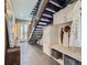 Grand entryway with modern staircase, storage bench with coat hooks and decor at 28665 Tepees Way, Evergreen, CO 80439
