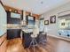 Modern kitchen with dark cabinetry, stainless steel appliances, and a stylish island with seating at 28665 Tepees Way, Evergreen, CO 80439