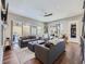 Spacious living room featuring hardwood floors, lots of natural light, neutral tones, and sliding door to balcony at 28665 Tepees Way, Evergreen, CO 80439