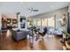 Open living space with modern furnishings, fireplace, flatscreen TV, hardwood floors, and access to a balcony at 28665 Tepees Way, Evergreen, CO 80439