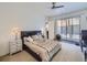 Relaxing bedroom featuring modern decor, neutral tones, a large window and a ceiling fan at 28665 Tepees Way, Evergreen, CO 80439