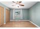 Empty room featuring hardwood flooring, ceiling fan, and window with natural light at 12251 Niagara Ct, Brighton, CO 80602