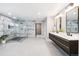 Spacious bathroom with marble walls, double vanity sinks, and a glass-enclosed shower with a rainfall showerhead at 11911 E Lake Cir, Greenwood Village, CO 80111